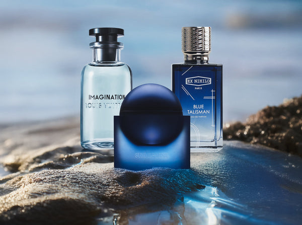 summer perfumes for men displayed on wet beach rocks